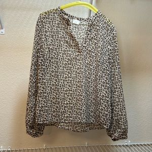 A cheetah print blouse from the brand new day in the size medium